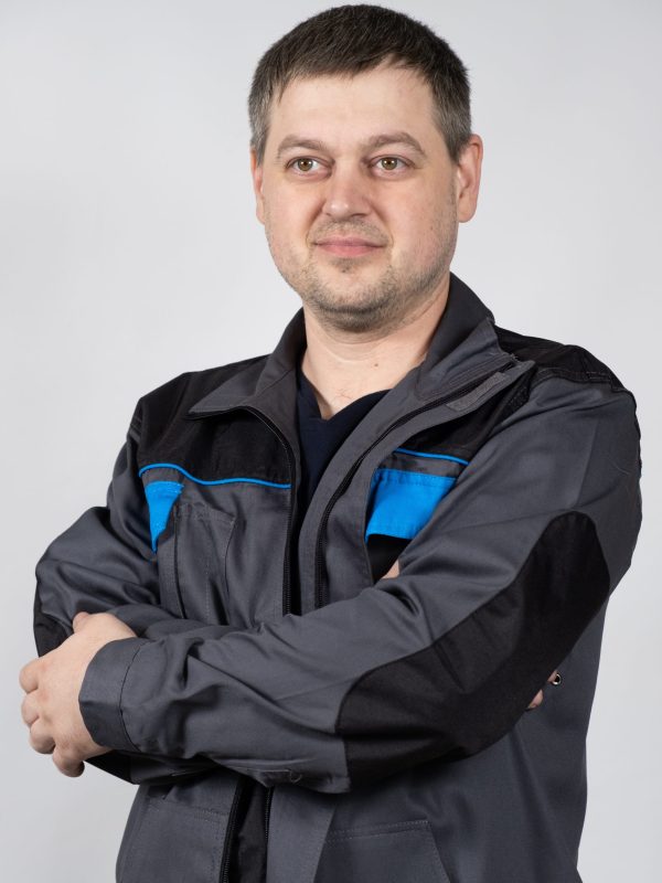 Portrait of a man in working overalls on a white background